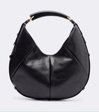 A black leather hobo handbag with gold-tone hardware, shown against a light gray background.