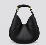 A black pebbled leather hobo handbag with a curved top handle, gold-tone hardware, and a subtle stitched geometric pattern, shown against a light gray background.